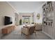 Open living room with built-in shelving, shiplap wall detail, and comfortable seating arrangement at 20670 Bridlewood Ln, Parker, CO 80138