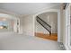 Bright living room with archways, a staircase with black railing, and carpet floors at 20670 Bridlewood Ln, Parker, CO 80138