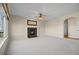 Spacious living room with a fireplace, large window, ceiling fan and neutral carpet at 20670 Bridlewood Ln, Parker, CO 80138