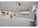 Open floor plan living room and kitchen with lots of light and neutral carpet at 20670 Bridlewood Ln, Parker, CO 80138