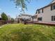 Exterior view of home and lawn featuring a wooden deck and partial fencing at 5204 S Parfet Way, Littleton, CO 80127