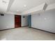 Finished basement with gray walls, neutral carpet, and a wood door at 5204 S Parfet Way, Littleton, CO 80127