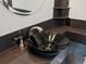 Close up on a stylish modern vanity with a vessel sink and bronze fixtures at 5204 S Parfet Way, Littleton, CO 80127