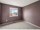 Bedroom featuring neutral carpet, purple walls, and a window with a neighborhood view at 5204 S Parfet Way, Littleton, CO 80127