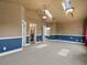 Bedroom with vaulted ceiling, skylights, and attached bathroom at 5204 S Parfet Way, Littleton, CO 80127