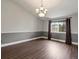 Elegant dining room with hardwood floors, modern lighting, and large window at 5204 S Parfet Way, Littleton, CO 80127