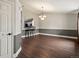 Elegant dining room with hardwood floors, modern lighting, and a convenient pass-through to the kitchen at 5204 S Parfet Way, Littleton, CO 80127