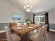 Dining room with hardwood floors, modern table set and natural light from the window at 5204 S Parfet Way, Littleton, CO 80127