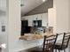 Modern kitchen featuring a breakfast bar with seating, granite countertops, and stainless steel appliances at 5204 S Parfet Way, Littleton, CO 80127