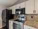 Kitchen area with stainless steel appliances and granite countertops at 5204 S Parfet Way, Littleton, CO 80127