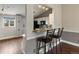 Open kitchen featuring granite countertops, breakfast bar, and modern finishes at 5204 S Parfet Way, Littleton, CO 80127
