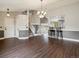 Bright and airy living room featuring hardwood floors, staircase and view into the kitchen at 5204 S Parfet Way, Littleton, CO 80127