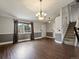 Bright and airy living room boasting hardwood floors, a staircase, and a large window at 5204 S Parfet Way, Littleton, CO 80127