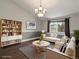 Bright living room with vaulted ceilings, modern furnishings, and a view from the window at 5204 S Parfet Way, Littleton, CO 80127