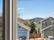 Neighborhood view through a window showing well-kept homes and landscaping at 5204 S Parfet Way, Littleton, CO 80127