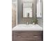 Modern bathroom features a stylish vanity, mirrored cabinet, and sleek fixtures at 9632 W Cornell Pl, Lakewood, CO 80227