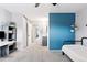 Large bedroom has ample space, blue accent wall, closet, and comfortable furniture at 9632 W Cornell Pl, Lakewood, CO 80227