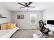 Bright bedroom with a daybed, large window, and a dedicated workspace at 9632 W Cornell Pl, Lakewood, CO 80227