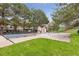 Community pool with a grassy area, perfect for summer relaxation and recreation at 9632 W Cornell Pl, Lakewood, CO 80227