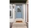 Close up of a blue front door with decorative glass and a brown door mat at 9632 W Cornell Pl, Lakewood, CO 80227