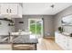 Bright kitchen features stainless steel appliances, granite counters, wood floors, and sliding glass door to the backyard at 9632 W Cornell Pl, Lakewood, CO 80227