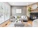 Cozy living room with a gray sofa, stone fireplace, and hardwood floors at 9632 W Cornell Pl, Lakewood, CO 80227