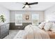 Comfortable main bedroom features neutral tones, a ceiling fan, and large windows at 9632 W Cornell Pl, Lakewood, CO 80227