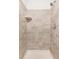 Tiled shower with shower head and built in shelf at 9632 W Cornell Pl, Lakewood, CO 80227