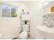 Simple bathroom featuring a toilet, sink, and a window at 1760 W 74Th Way, Denver, CO 80221