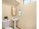 Cozy bathroom with a pedestal sink and a neutral color scheme, creating a clean and simple space at 1760 W 74Th Way, Denver, CO 80221