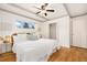 Bright bedroom with hardwood floors, ceiling fan, a window view, and a closet at 1760 W 74Th Way, Denver, CO 80221