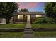 Charming brick home featuring a well-manicured lawn and inviting front porch at 1760 W 74Th Way, Denver, CO 80221