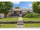 Charming brick home featuring a well-manicured lawn and inviting front porch at 1760 W 74Th Way, Denver, CO 80221