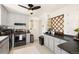 Functional kitchen with light gray cabinets, stainless appliances, and ample counter space at 1760 W 74Th Way, Denver, CO 80221