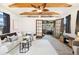Comfortable living room with vaulted ceilings, hardwood beams, and a doorway leading to a sunroom at 1760 W 74Th Way, Denver, CO 80221