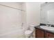Bright bathroom featuring a shower-tub combination and vanity with a dark countertop at 4100 Albion St # 617, Denver, CO 80216