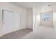 Comfortable bedroom with neutral carpet, closet and bright window at 4100 Albion St # 617, Denver, CO 80216