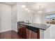 Modern kitchen island featuring granite countertops, a stainless steel dishwasher, and pendant lighting at 4100 Albion St # 617, Denver, CO 80216