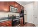 Well-equipped kitchen with stainless steel appliances, granite countertops and wood cabinets at 4100 Albion St # 617, Denver, CO 80216