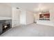 Bright living room featuring a fireplace, neutral carpet and an open layout to the kitchen at 4100 Albion St # 617, Denver, CO 80216