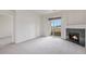 Cozy living room with a fireplace, balcony access and neutral carpet at 4100 Albion St # 617, Denver, CO 80216