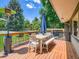 Inviting back deck with a dining table set, bench seating and string lights, perfect for outdoor enjoyment at 5254 W Oberlin Dr, Denver, CO 80235