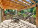 Beautiful back patio with stone walls, stone steps and a table seating, perfect for outdoor enjoyment at 5254 W Oberlin Dr, Denver, CO 80235