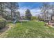 Lush backyard with green grass featuring a playground and other backyard features at 5254 W Oberlin Dr, Denver, CO 80235