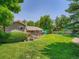 Expansive backyard featuring a well-maintained lawn, mature trees, and a wooden deck perfect for outdoor entertaining at 5254 W Oberlin Dr, Denver, CO 80235