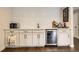 Stylish bar area with cabinets, a beverage cooler, and modern finishes at 5254 W Oberlin Dr, Denver, CO 80235