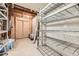 Unfinished basement featuring metal shelving, visible pipes, and unfinished walls at 5254 W Oberlin Dr, Denver, CO 80235