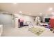 Large finished basement providing play area with toys, mats, mini basketball hoop, and gym equipment at 5254 W Oberlin Dr, Denver, CO 80235