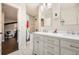 Bathroom with double vanity and a tiled shower with a patterned shower curtain at 5254 W Oberlin Dr, Denver, CO 80235
