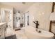 Beautiful bathroom with a soaking tub, walk in shower and modern tile flooring at 5254 W Oberlin Dr, Denver, CO 80235